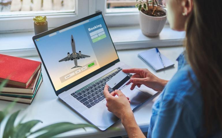 Woman booking plane tickets online
