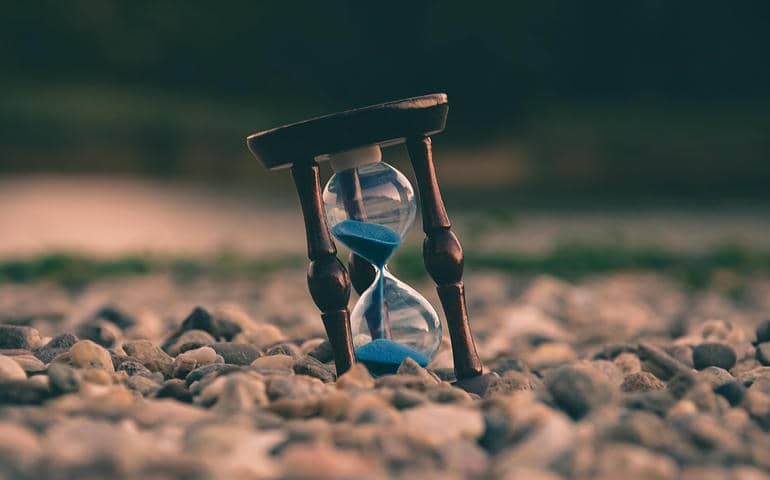 An hourglass kept on stones

