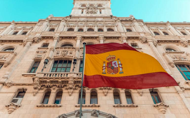 Spain flag in front of a building
