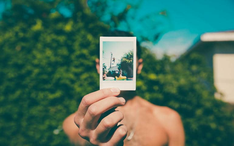 A man showing a photograph
