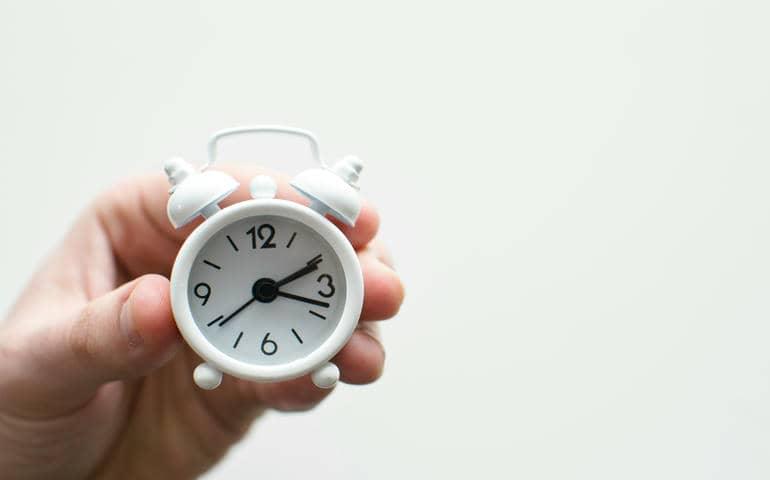Alarm clock in the hand