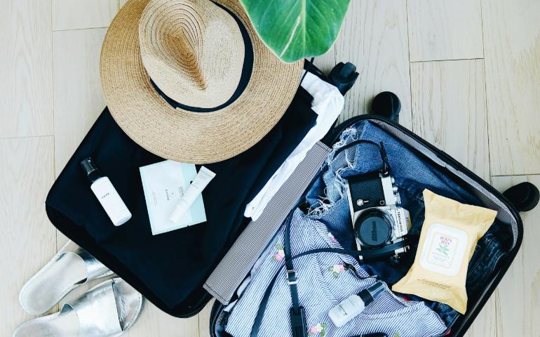 Suitcase with travel essentials