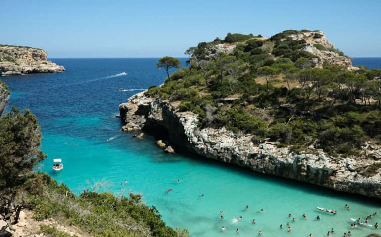 People swimming on the beach.
