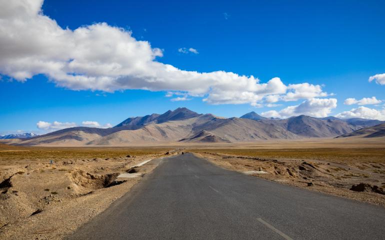 Desert road leading to the mountains in Ladakh.