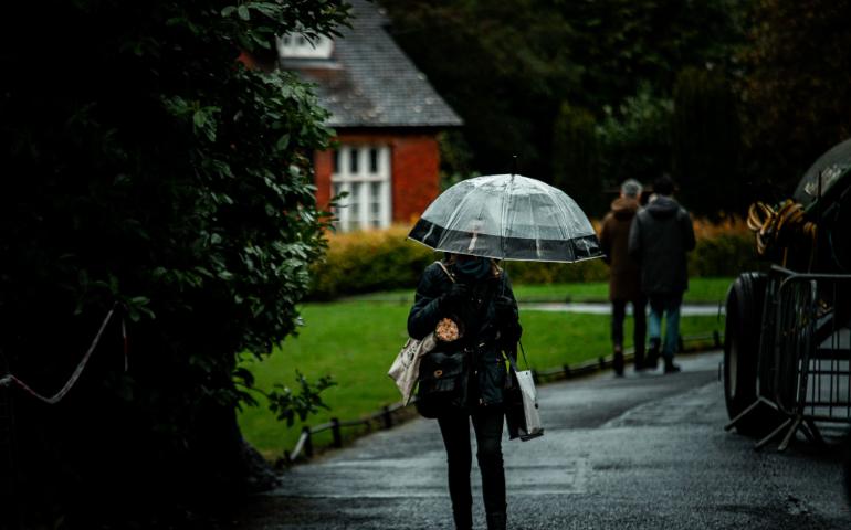 A Person Walking With a Clear Umbrella on a Rainy Day