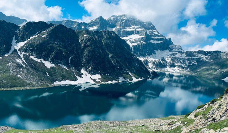 Mountains reflecting on a lake with clear blue skies
Basim Lone/Pexels