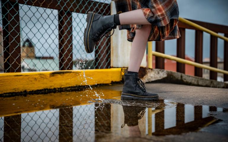 Vibe of Boots Splashing on a Rainy Urban