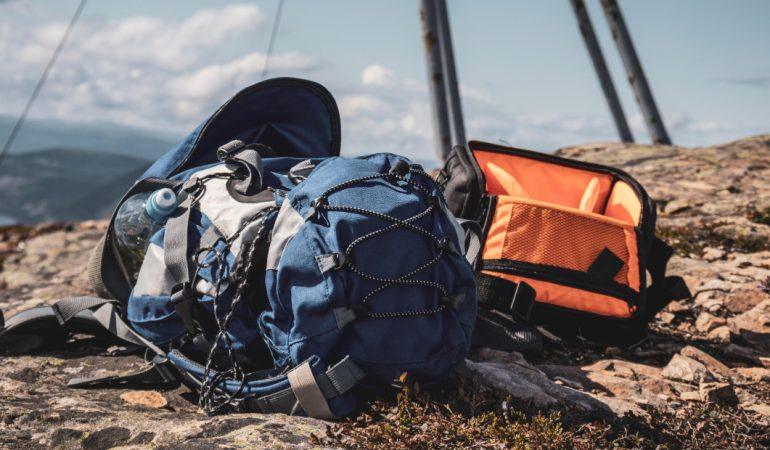 Blue and orange backpacks resting on a rocky mountain peak under a clear sky
Image Credit:  Jędrzej Koralewski/Pexels