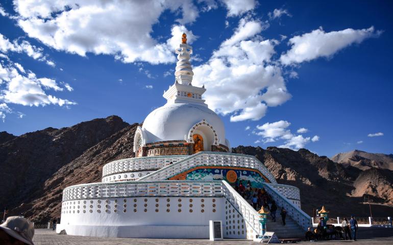 Capture of the Shanti Stupa against a stunning mountainous landscape.