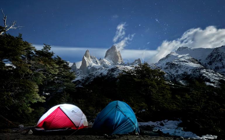 Stunning Night View of Tents Between Mountains