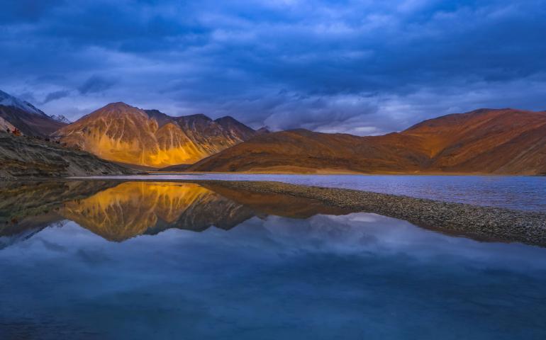 Stunning view of Leh mountains reflected in a tranquil lake at sunset
