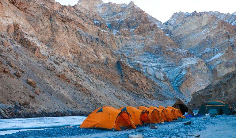 Row of orange tents on a rocky terrain against majestic mountains in Ladakh at daylight
Image Credit: Sakshi Patwa/Pexells