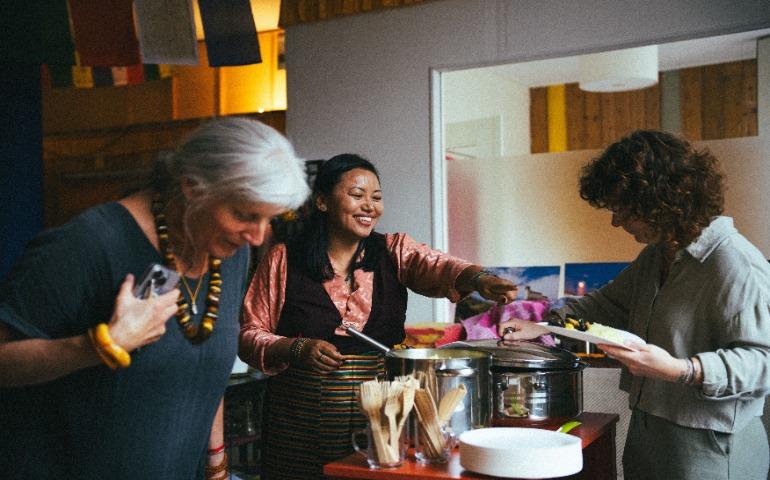 Women laughing and serving food