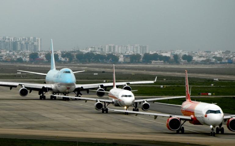 Airplanes Taxi on Runway at Bustling Airport