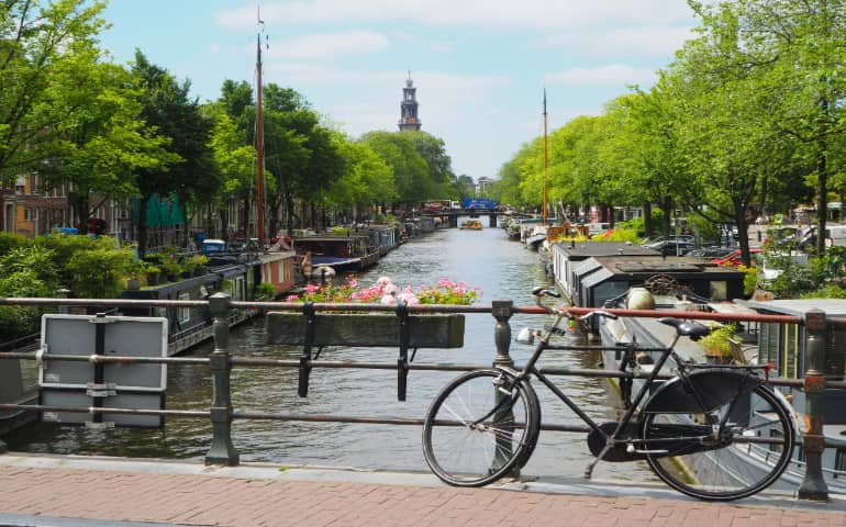 Black city bike near the canal in Amsterdam