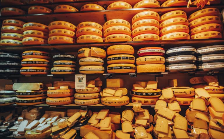 A shelf filled with lots of Dutch cheese
