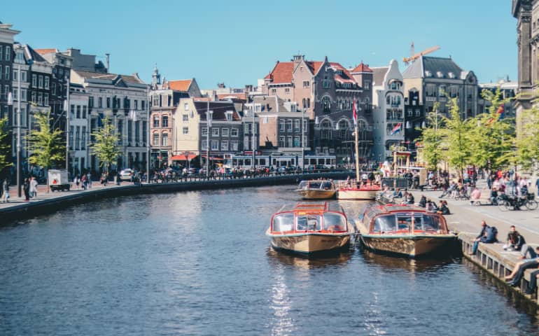 Boats parked in the canal in Amsterdam
