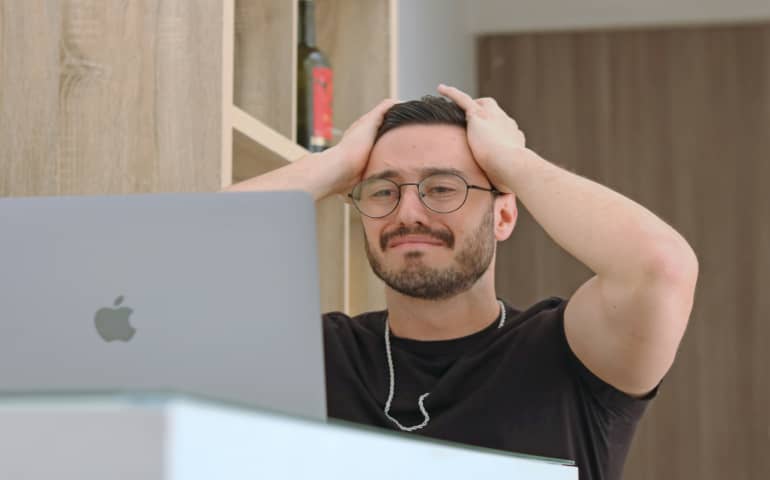 A man holding his hands on his head