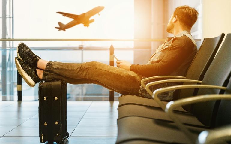 A traveler relaxing while waiting at the airport