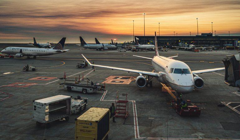 Airplanes parked at a busy airport terminal during sunset, showcasing aviation and travel
Image Credit: Brett Sayles/Pexels
