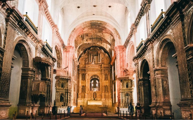 Stunning interior of historic Goa cathedral with ornate gothic architecture. 