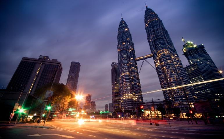 Kuala Lumpur at night showcasing iconic Petronas Towers and urban lights