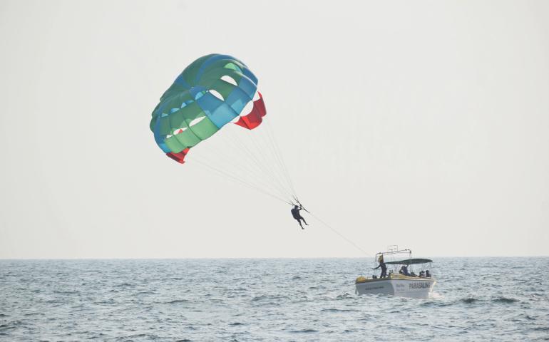 A thrilling parasailing experience over the sea with a colorful parachute and speedboat.
Image Credit: Pranav Chaugule/Pexels
