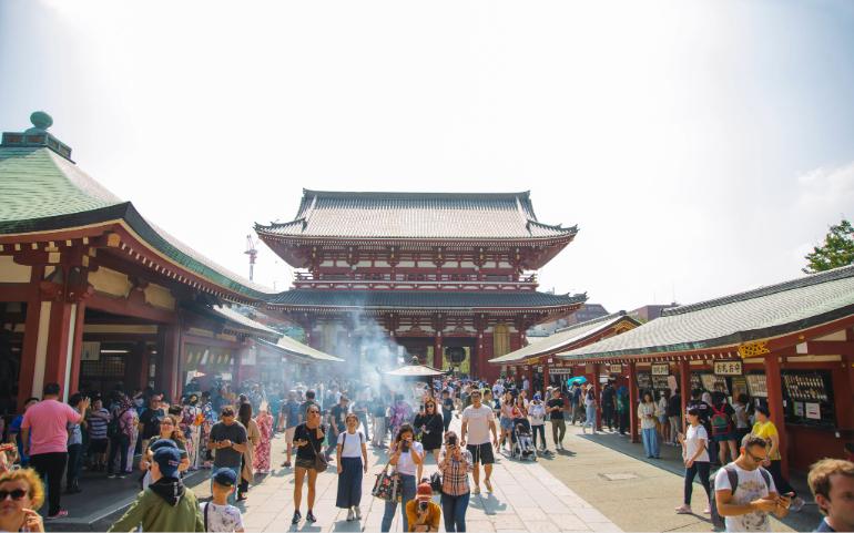 A vibrant crowd at Senso-ji Temple in Tokyo, Japan, capturing the essence of culture and tourism