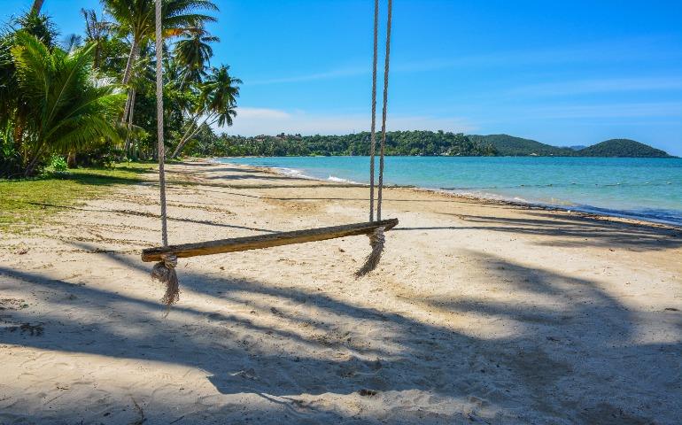 View of a sandy beach with a swing on Ko Mak, Thailand
