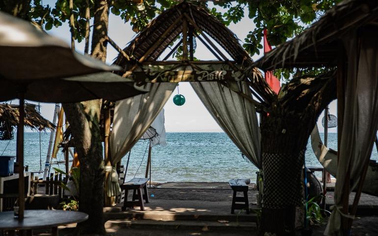 Relaxing beachfront gazebo setting in Bali with ocean views