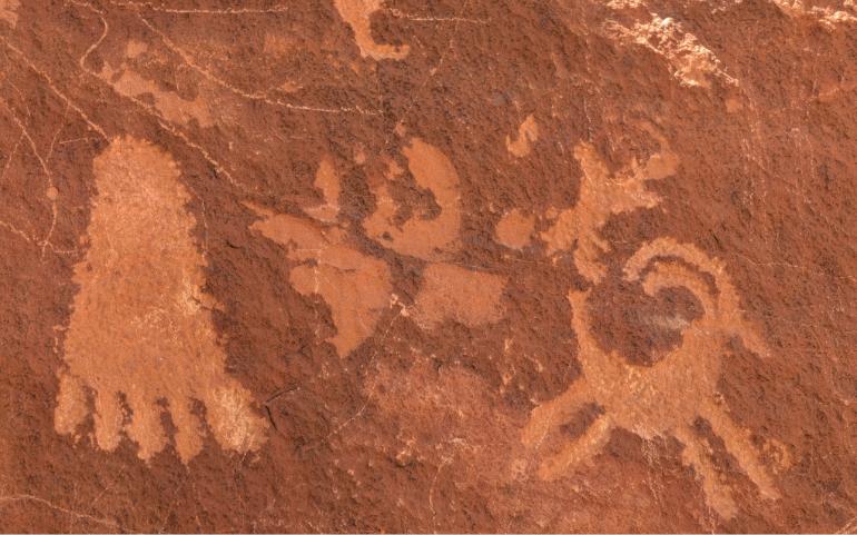 Detailed view of ancient petroglyphs on sandstone.