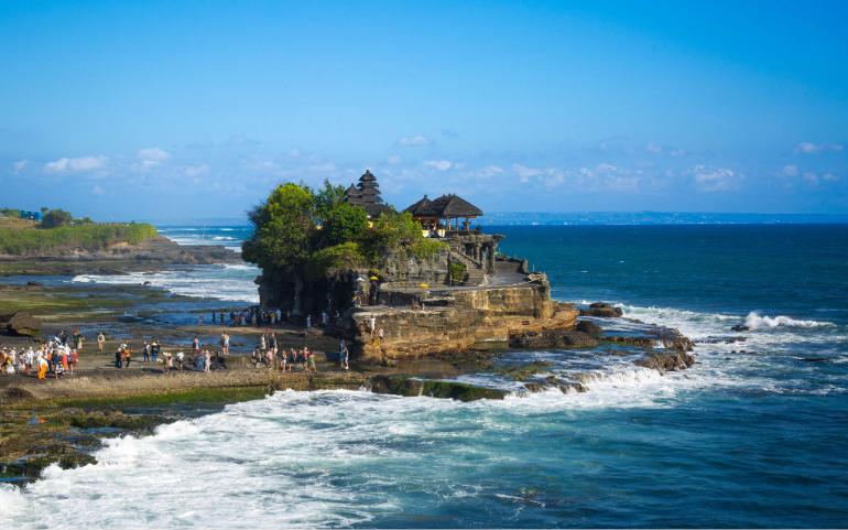 Iconic Tanah Lot Temple perched on a rocky coastline in Bali, Indonesia