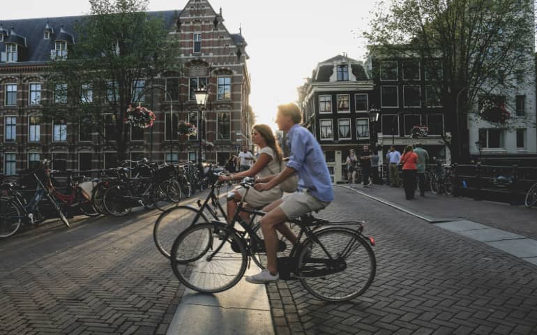 A couple exploring Amsterdam on cycle

