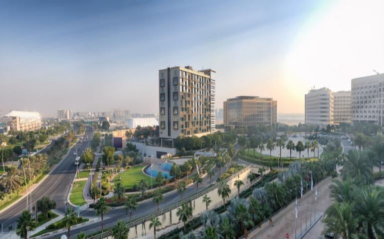 Aerial view of Abu Dhabi Yas Island skyline at sunset, UAE.