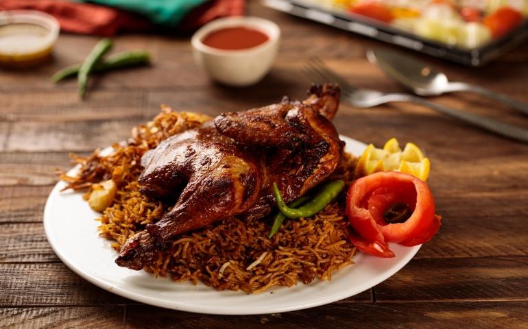 Chicken Machboos served with tomato sauce and salad