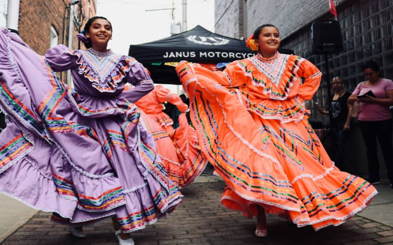Two Spanish girls dancing together
