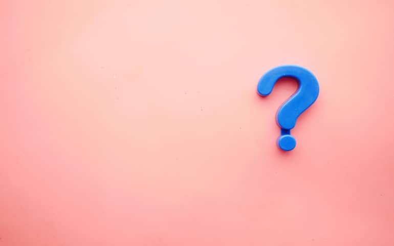 A blue question mark against pink background
