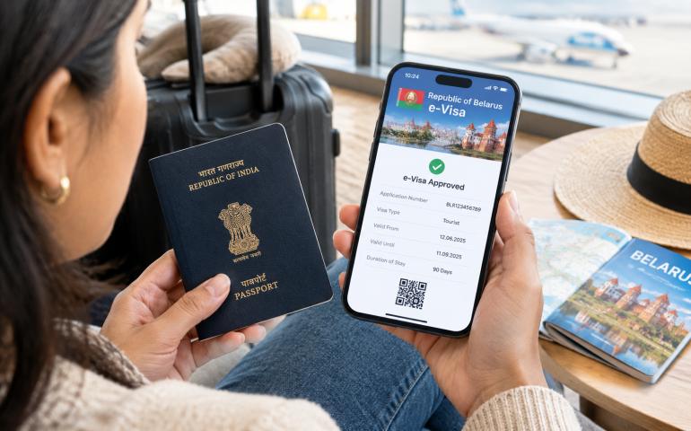 Indian traveller checking a Belarus e-visa on a phone beside a passport