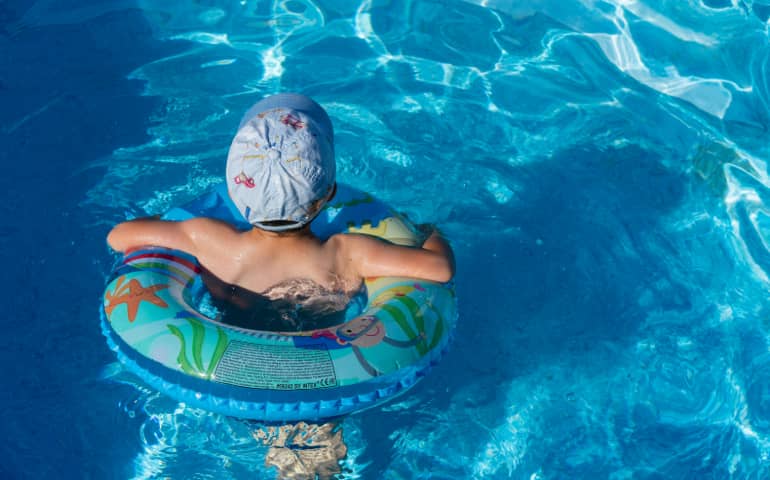 A kid enjoying at the pool
