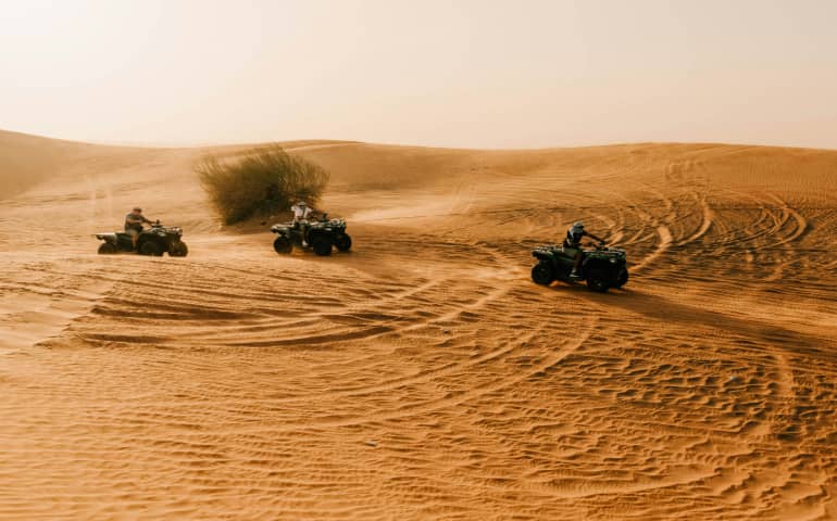 People riding ATV Bikes during a Desert Safari
