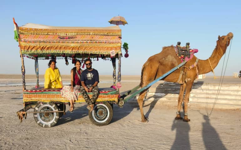 Three people on a camel ride in Rann of Kutch