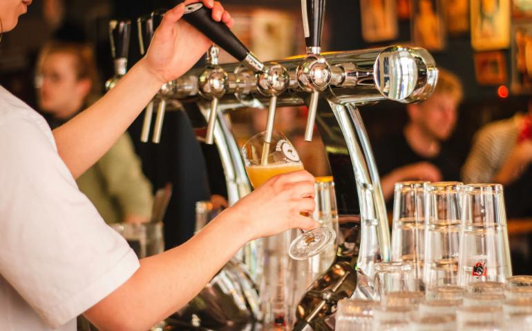 Person pouring beer into a glass