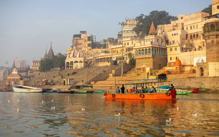 People on the boats in the river near the Varanasi Ghats
