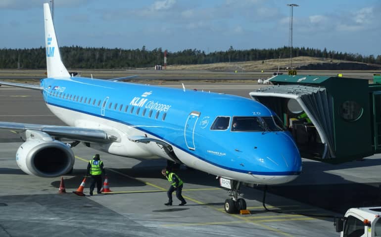 Two men doing some work near the airplane