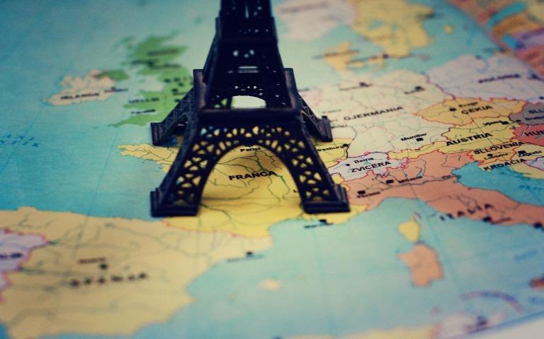 Miniature Eiffel Tower placed on a map of Europe, focusing on France
Image Credit: Adrian Limani/Pexels