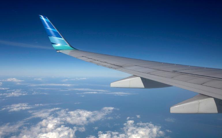 View from airplane wing high above clouds with blue sky
Image Credit: Jeffry Surianto/Pexels