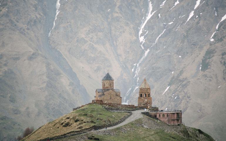 A historical church stands against a majestic mountain backdrop, Stepantsminda, Georgia
Image Credit: ArtHouse Studio/Pexels