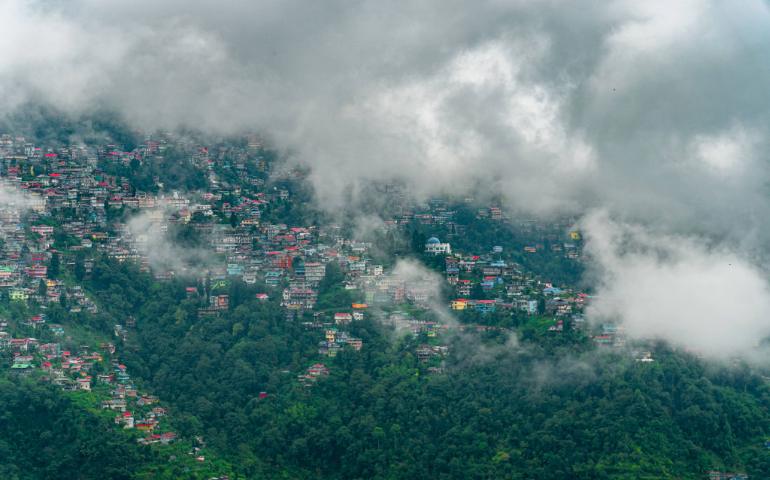 A scenic view of Darjeeling's colourful hillside under clouds.
Image Credit - Arto Suraj/Pexels