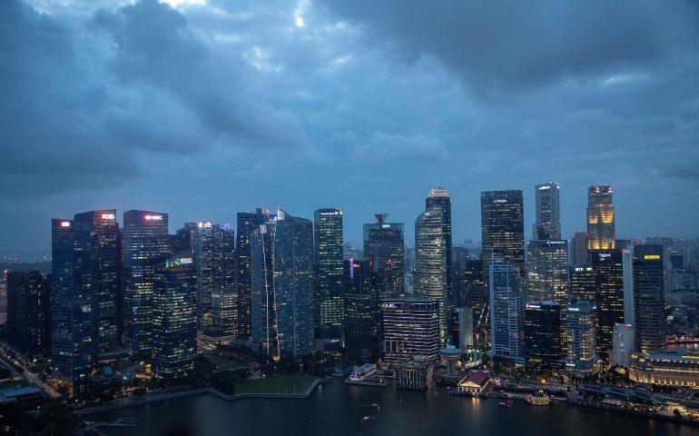 Aerial view of Singapore's illuminated skyline during the evening, featuring modern skyscrapers.
Image Credit: Bojána Noémi Molnár/Pexels