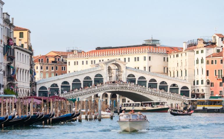 Iconic view of Rialto Bridge with bustling boats on the Grand Canal in Venice
Image Credit: Cristian Loayza/Pexels